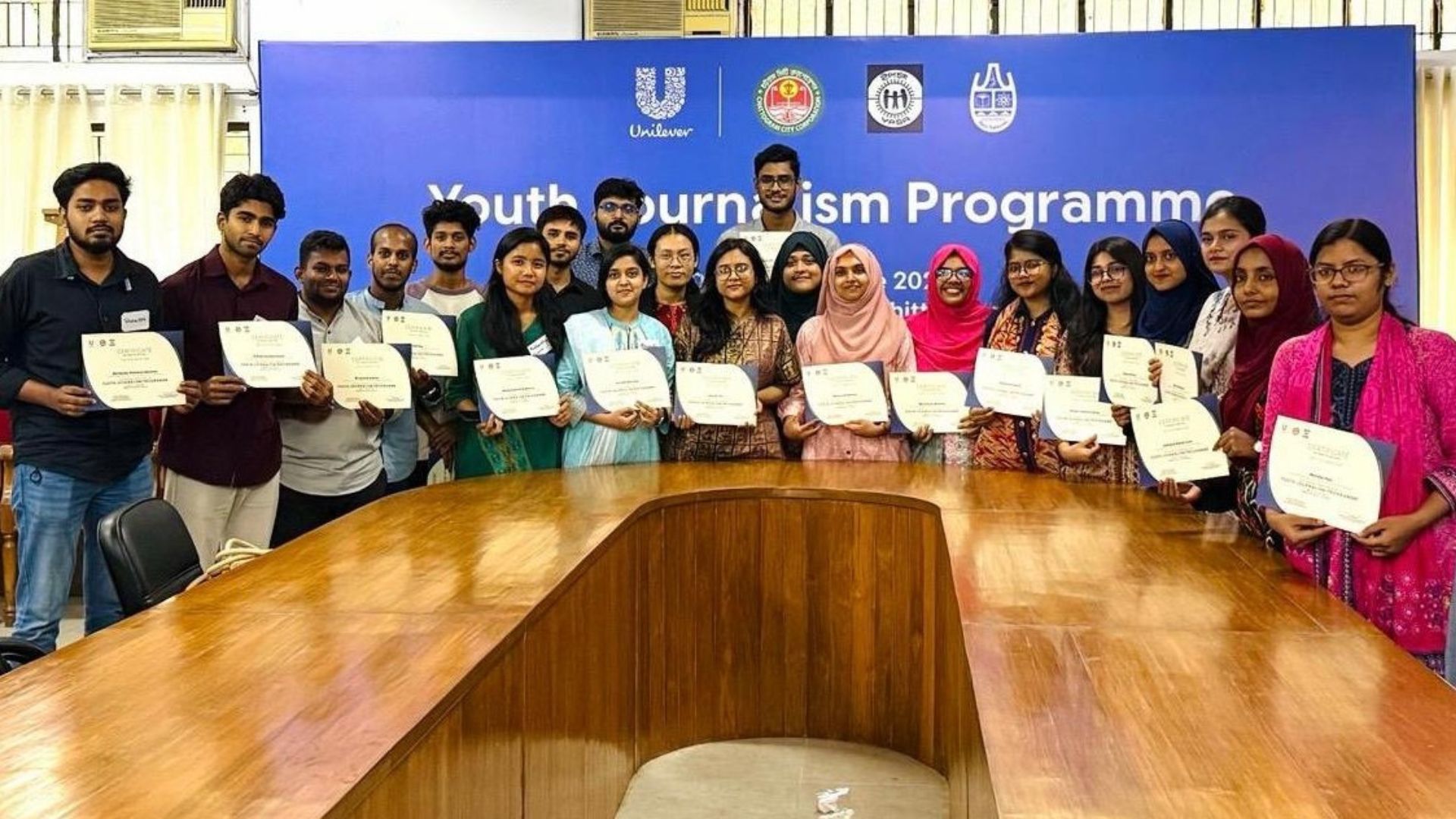 Students receiving certificates for participation.
