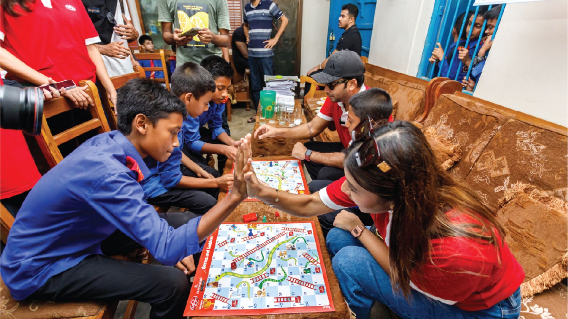 Volunteers and students engaging in H for Handwashing Games