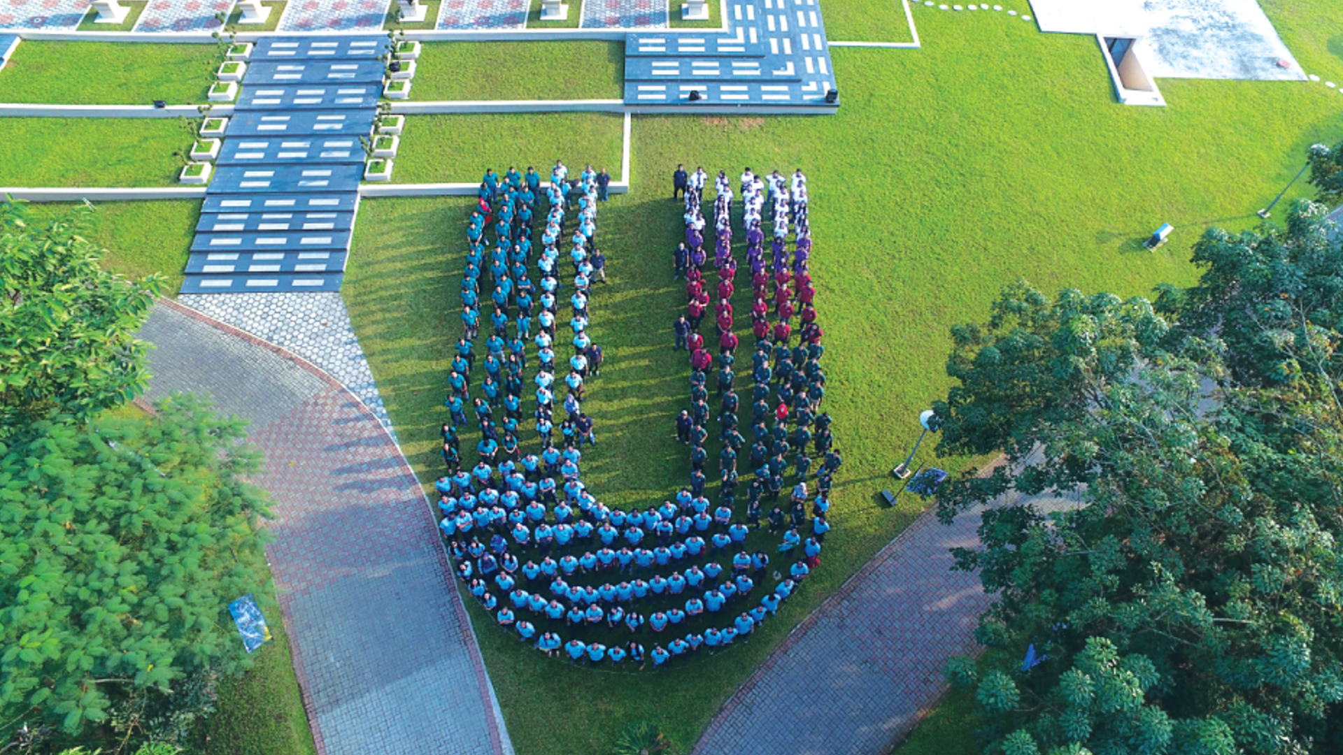 Drone shot of the Unilever factory employees in a shape of U