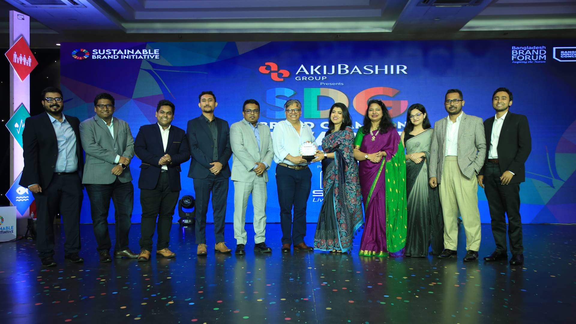 Group photo of UBL representatives on stage, receiving the award