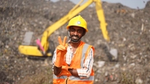Photo of a smiling male plastic waste sorting worker