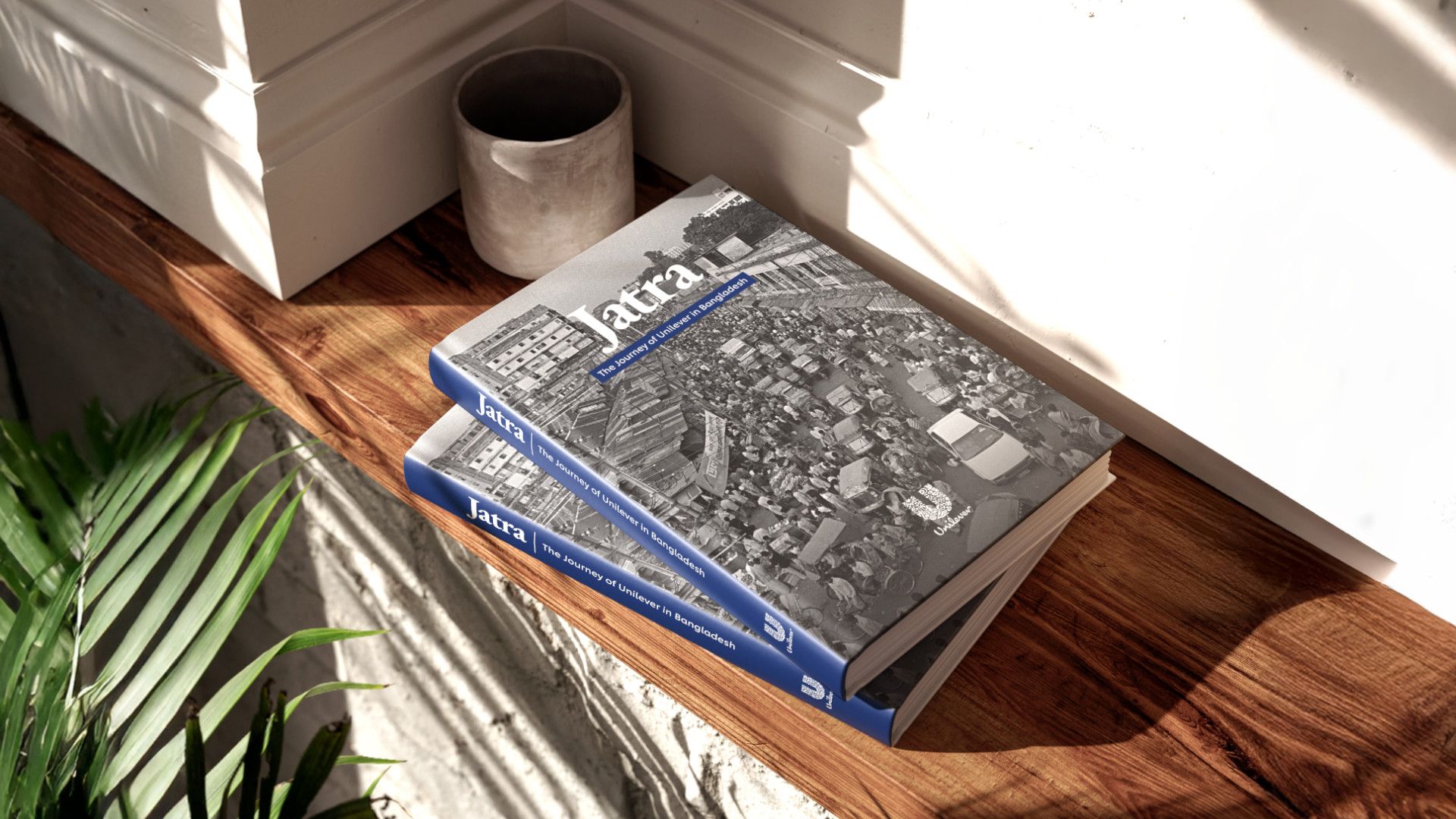 Three Jatra books kept on a side table