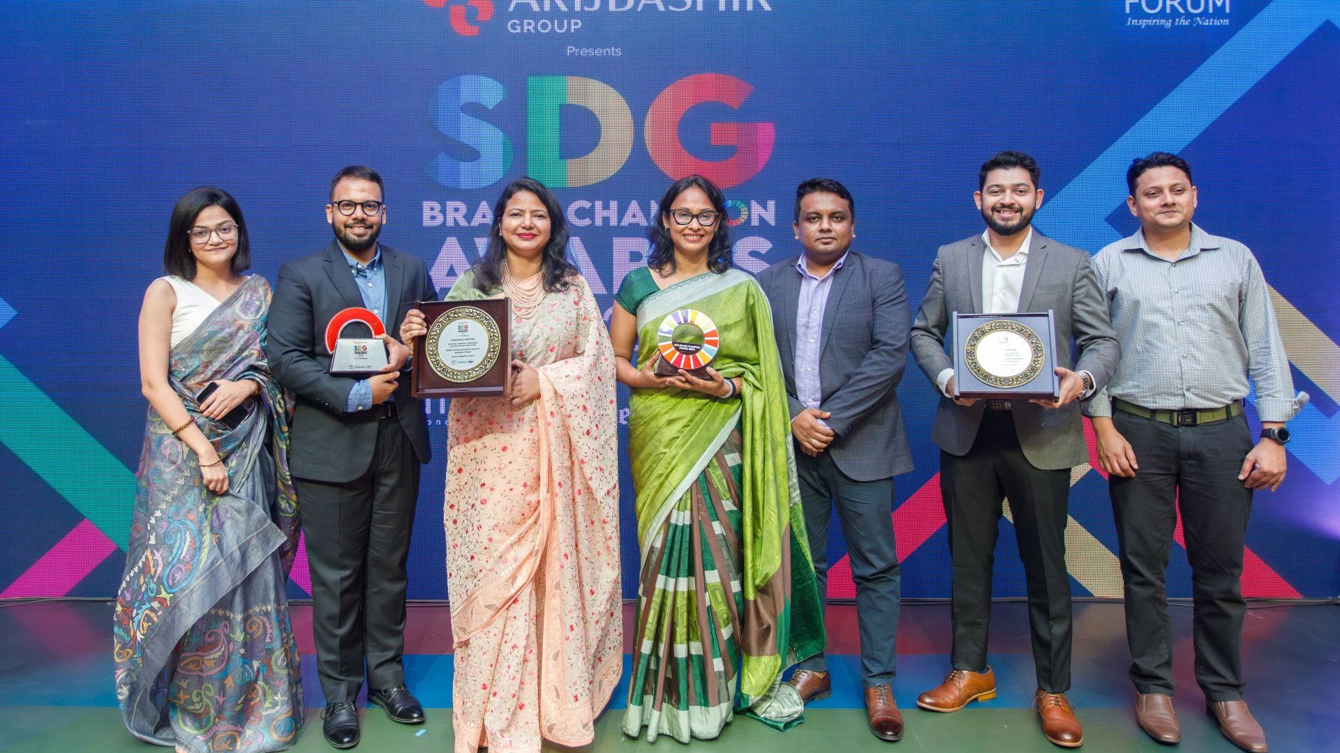 Unilever Bangladesh team group photo with award trophies and crests in hand.