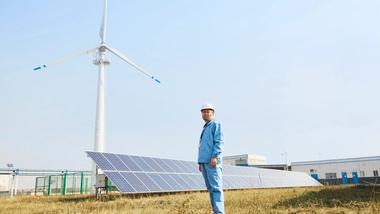 Man stood in front of solar panels