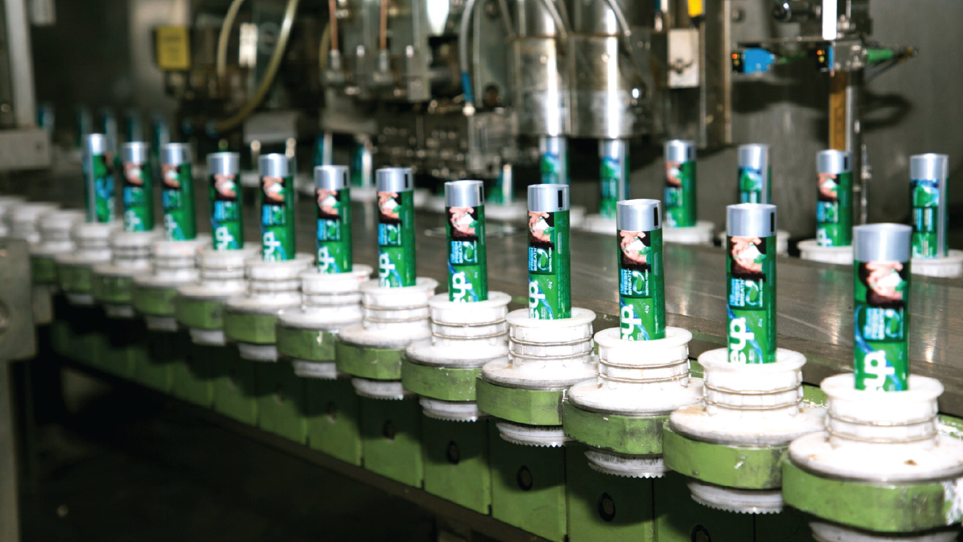  Close Up toothpaste being inserted on the tubes in the automated production belt.