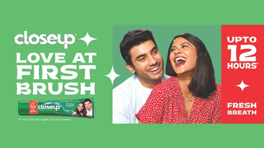 Couple smiling with Closeup toothpaste, text: “Love at first brush”
